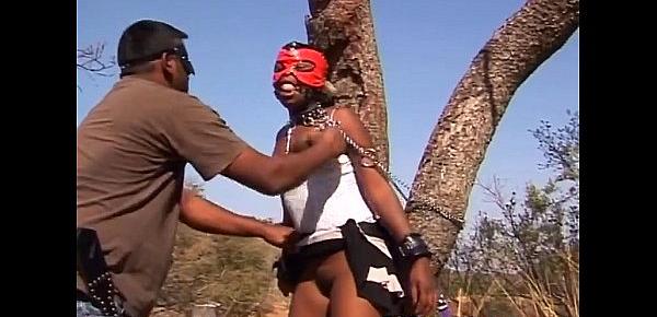  Torturing African slut outdoors tied up big tits
